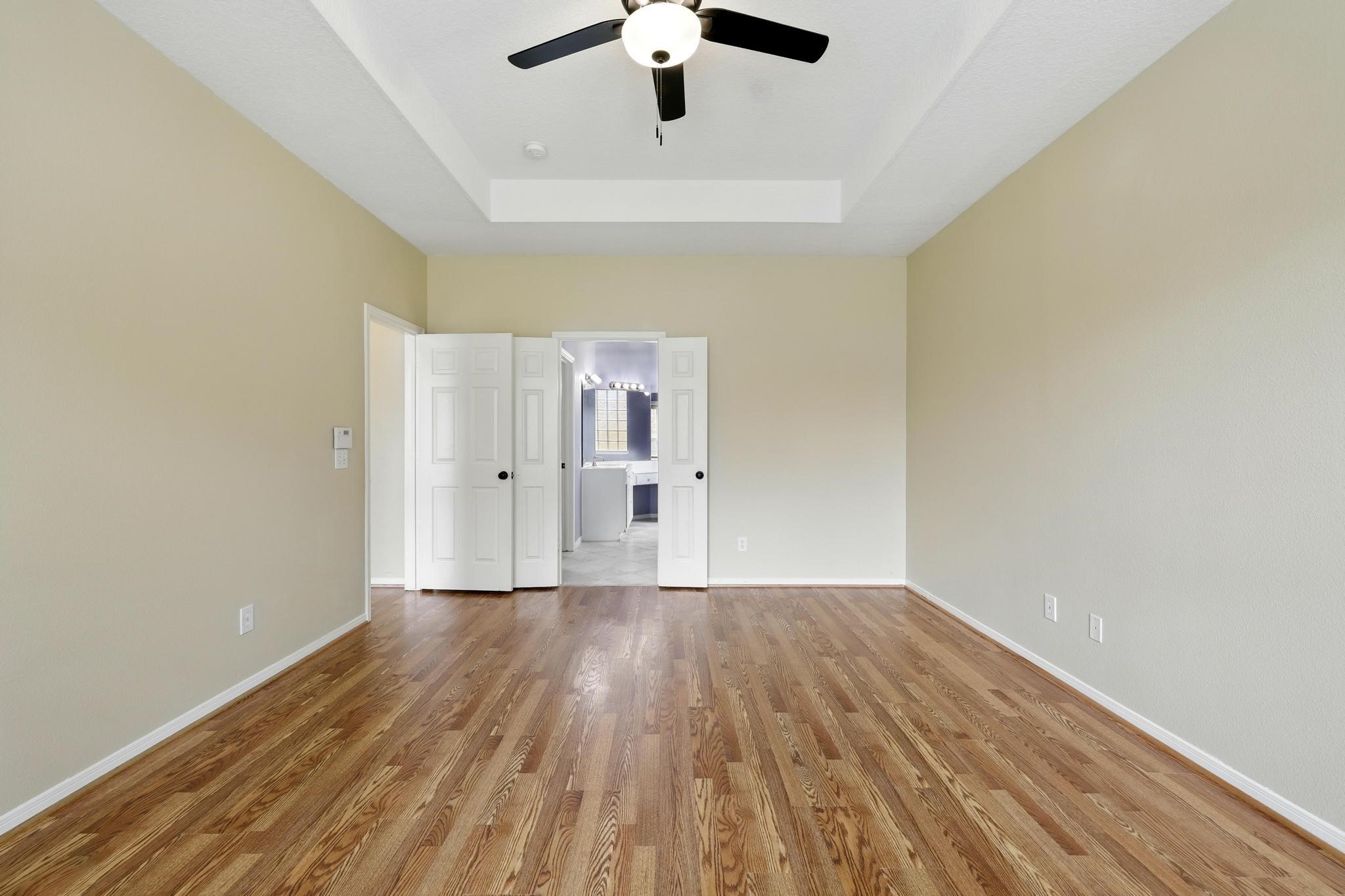 11030 Sprucedale Court Houston, TX 77070 - Photo 19 of 36 a view of wooden floor and a chandelier fan in a room