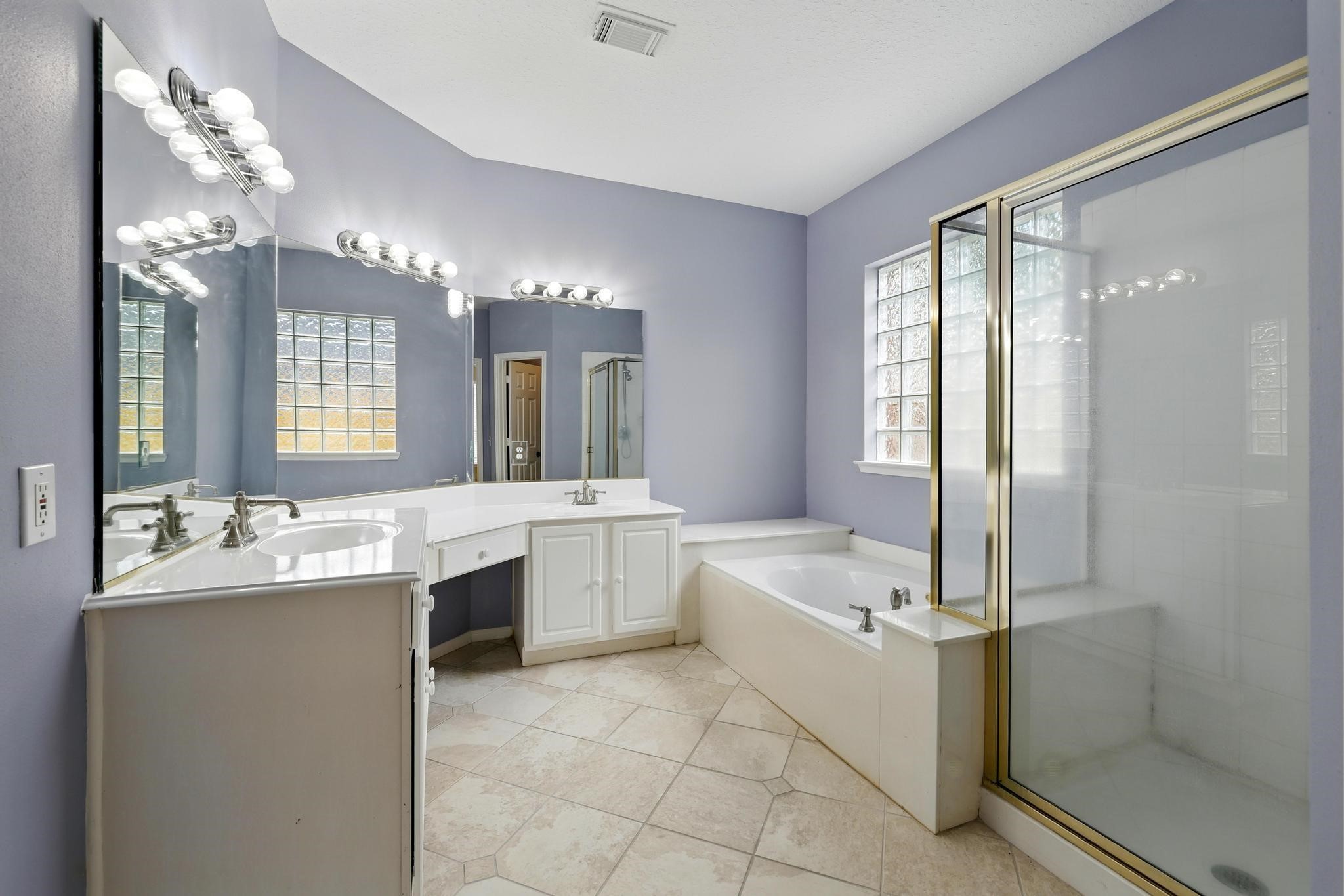 11030 Sprucedale Court Houston, TX 77070 - Photo 20 of 36 a large bathroom with a large tub sink and double vanity