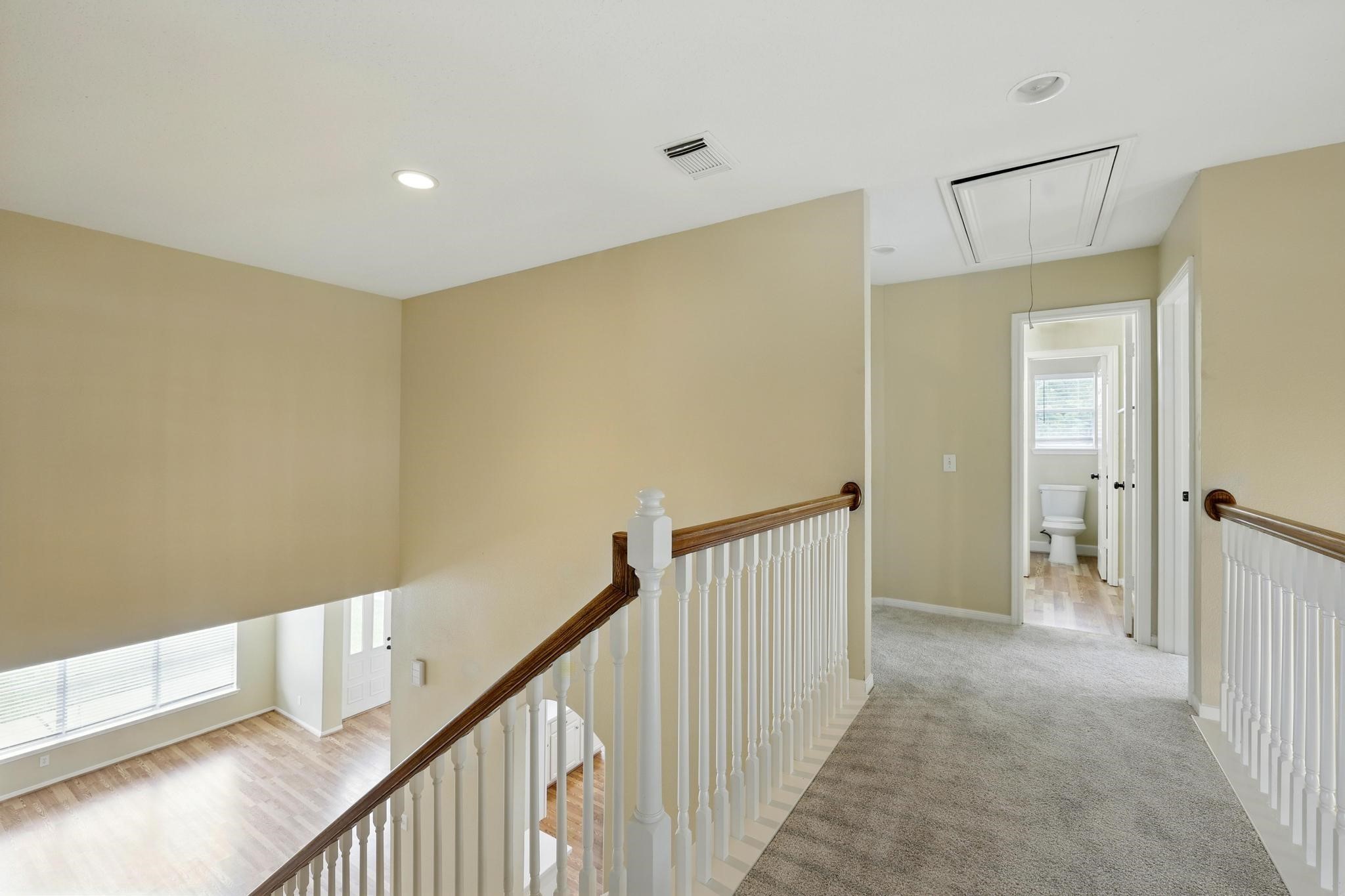 11030 Sprucedale Court Houston, TX 77070 - Photo 27 of 36 a view of a hallway with wooden floor