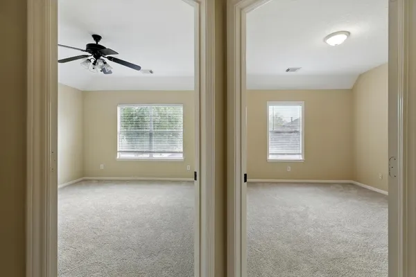 a view of a livingroom with a ceiling fan and window