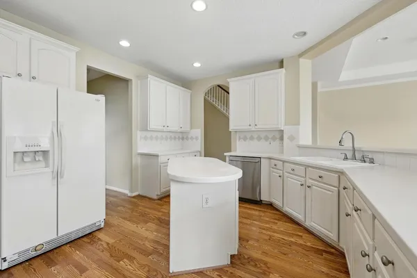 a kitchen with white cabinets and white appliances