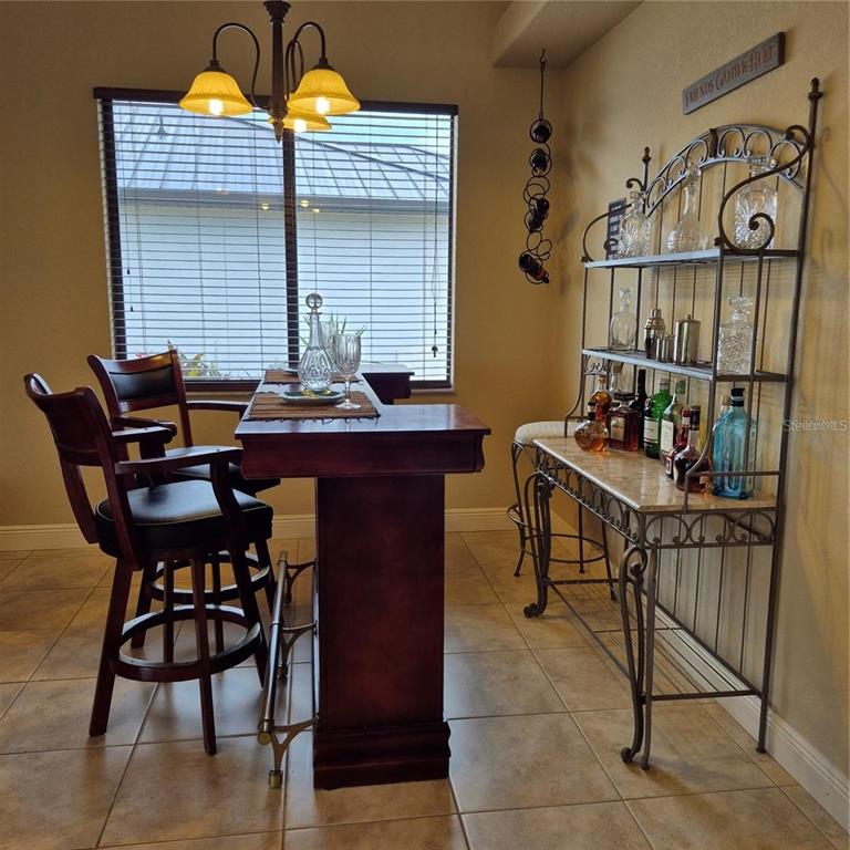 19 Medalist Way Rotonda West, FL 33947 - Photo 13 of 30 a table and chairs in a room