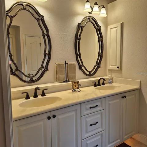 a bathroom with a double vanity sink and a mirror