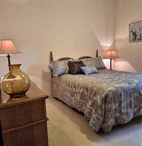 a bedroom with a bed and a lamp