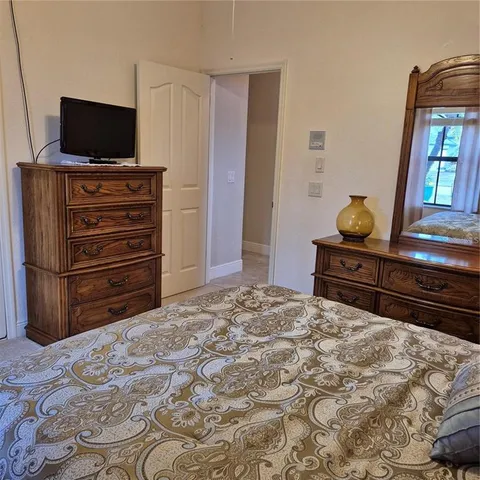 a bedroom with a bed and a television