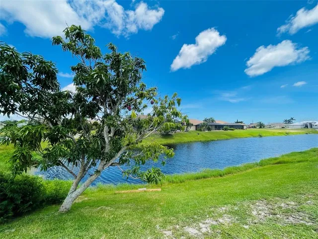 a view of a lake with houses in the back