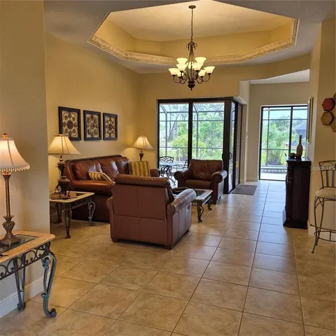 a living room with furniture and a chandelier