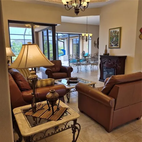 a living room with furniture a floor to ceiling window and a flat screen tv
