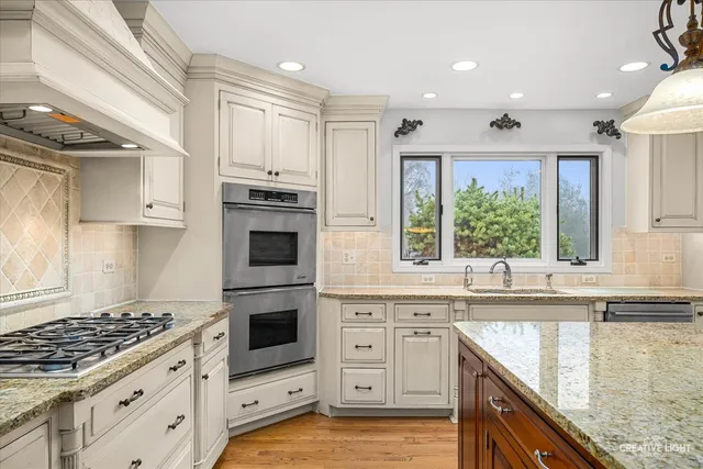 a kitchen with granite countertop a sink stove and cabinets