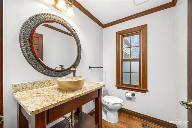 a bathroom with a toilet a sink and a window