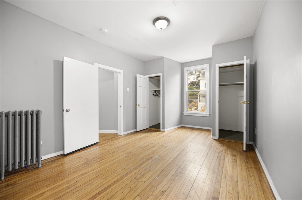 276 Washington Avenue, Unit 2 Chelsea, MA 02150 - Photo 12 of 28 an empty room with wooden floor and a window