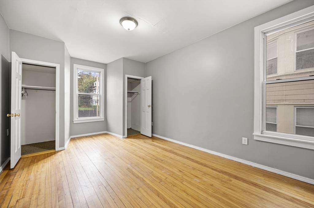 276 Washington Avenue, Unit 2 Chelsea, MA 02150 - Photo 14 of 28 a view of an empty room with wooden floor and a window