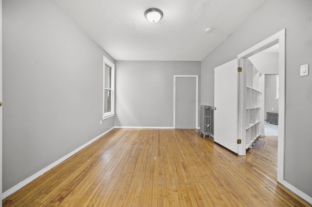 276 Washington Avenue, Unit 2 Chelsea, MA 02150 - Photo 15 of 28 wooden floor in an empty room with a window
