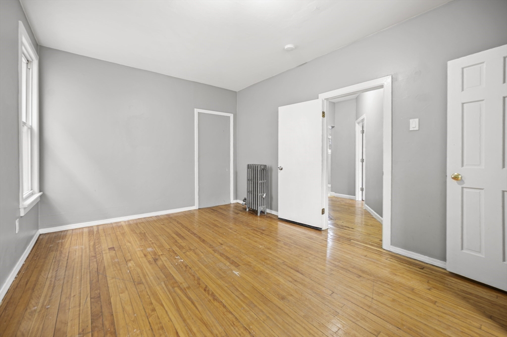 276 Washington Avenue, Unit 2 Chelsea, MA 02150 - Photo 16 of 28 a view of an empty room with wooden floor and a window