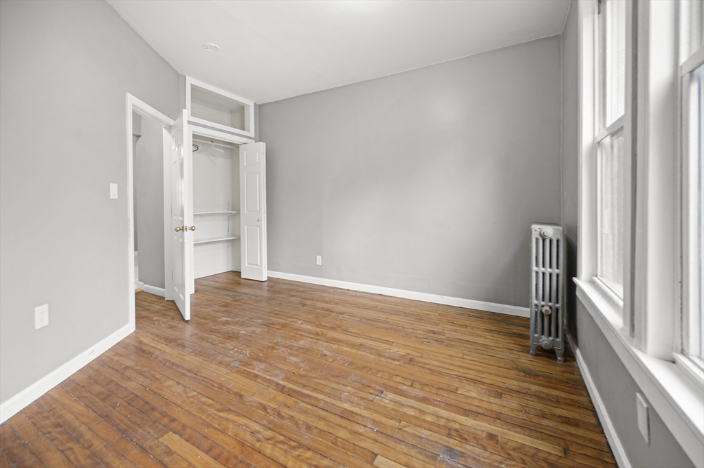 276 Washington Avenue, Unit 2 Chelsea, MA 02150 - Photo 17 of 28 a view of empty room with wooden floor and window