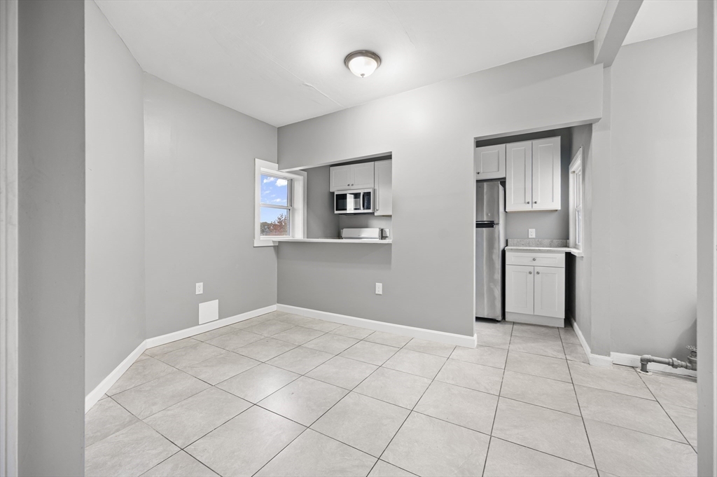 276 Washington Avenue, Unit 2 Chelsea, MA 02150 - Photo 2 of 28 a view of a kitchen with a dishwasher and a refrigerator