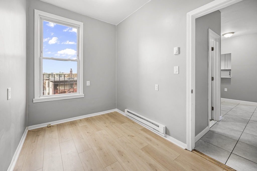 276 Washington Avenue, Unit 2 Chelsea, MA 02150 - Photo 22 of 28 a view of an empty room with window and wooden floor