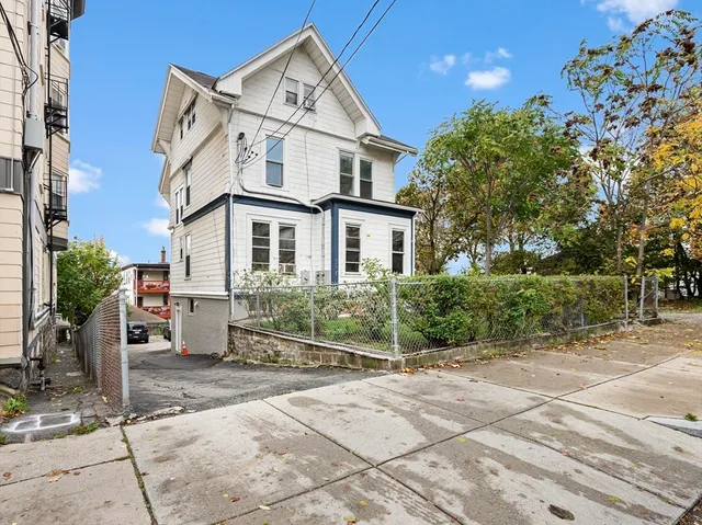 a view of a white house with a outdoor space