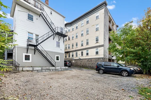 a car parked in front of white house