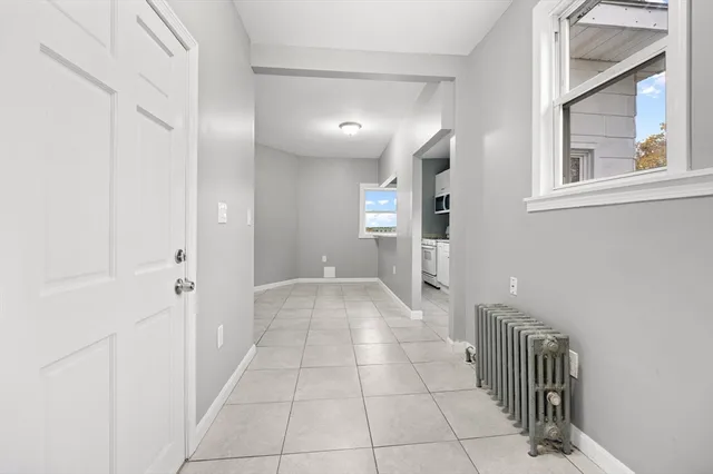 a view of a hallway with closet and a bathroom