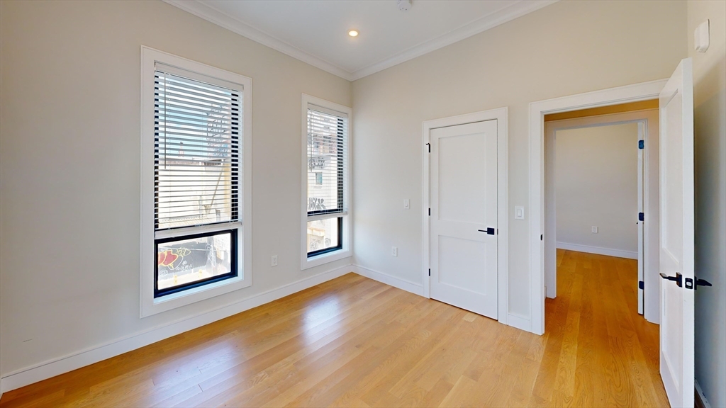 16-18 Highgate Street, Unit 202 Boston, MA 02134 - Photo 2 of 14 wooden floor in an empty room with a window