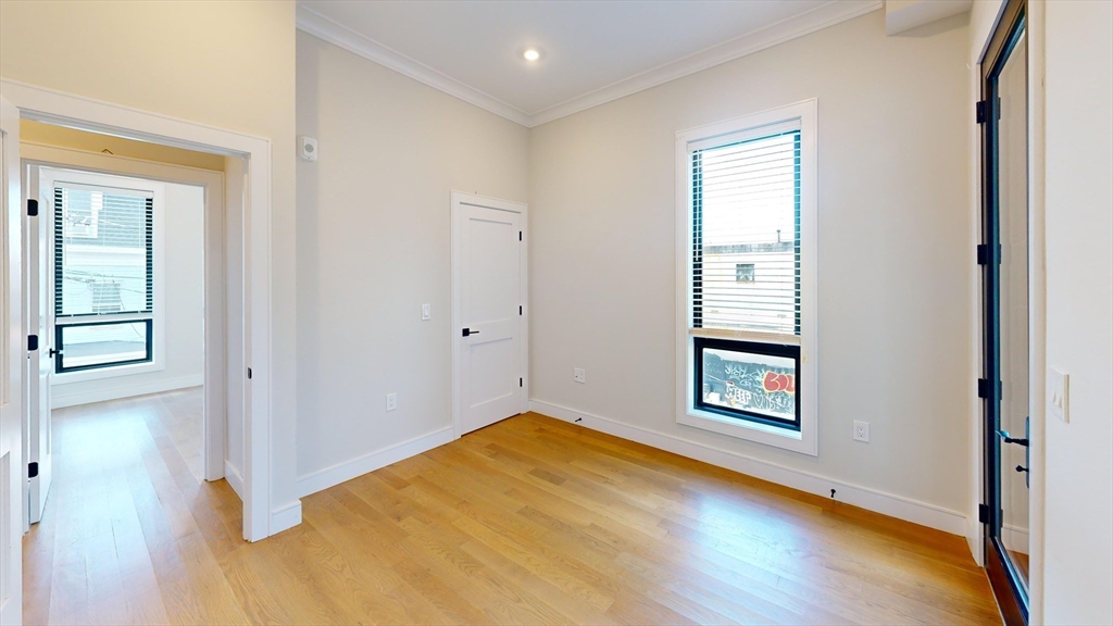 16-18 Highgate Street, Unit 202 Boston, MA 02134 - Photo 6 of 14 an empty room with windows and closet