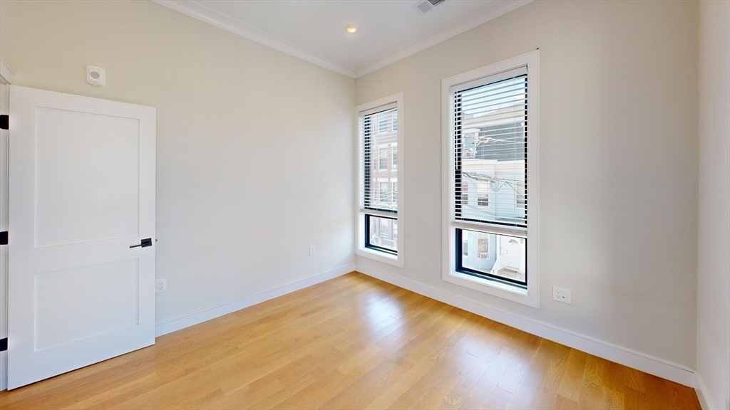 16-18 Highgate Street, Unit 202 Boston, MA 02134 - Photo 9 of 14 an empty room with windows