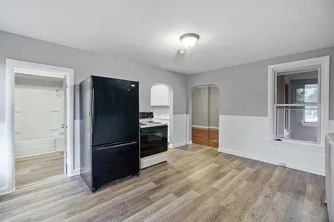 a kitchen with granite countertop a refrigerator and a sink