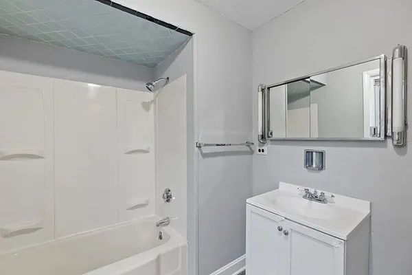 a bathroom with a sink mirror vanity and toilet