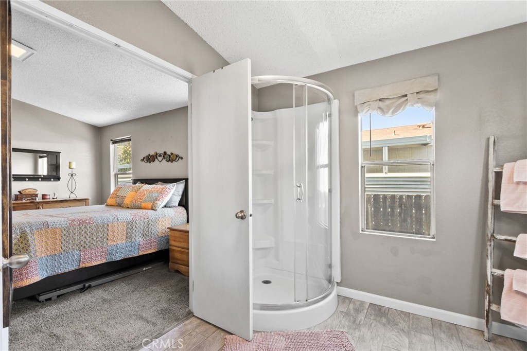 4901 Green River Road, Unit 303 Corona, CA 92878 - Photo 38 of 58 a bedroom with a bed and a mirror