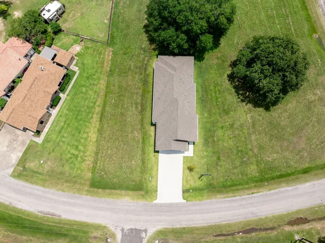 an aerial view of a residential houses with outdoor space and street view