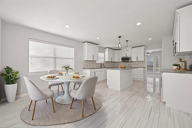 a view of an empty room with cabinet and utility room