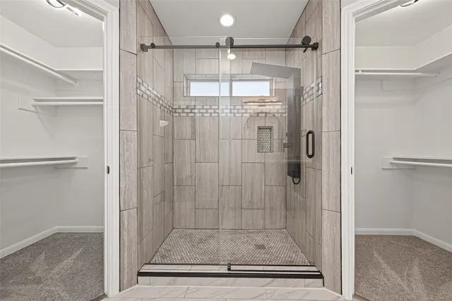 a spacious bathroom with a granite countertop sink a mirror and a