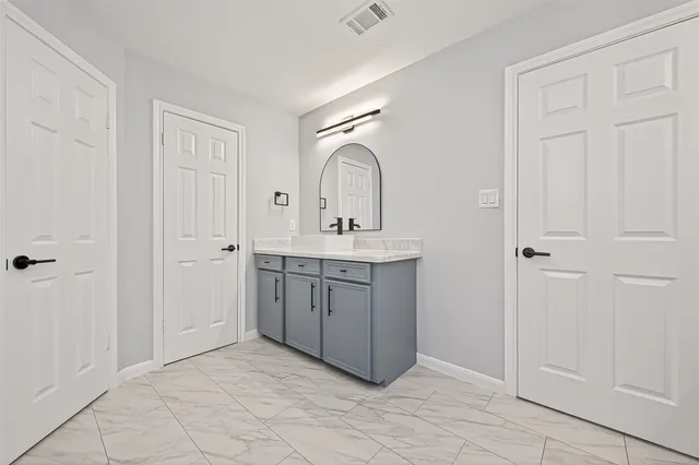 a view of walk in closet with empty racks