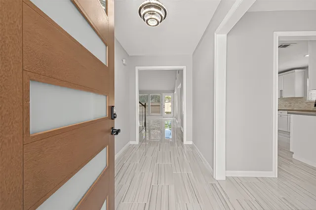 a view of a hallway with wooden floor