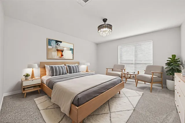 a bedroom with bed and a chandelier