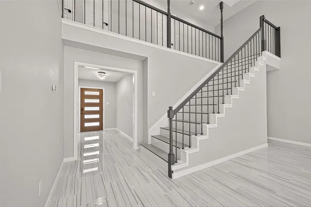 a living room with furniture a fireplace and a large window