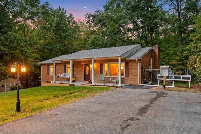 a front view of a house with a yard table and chairs