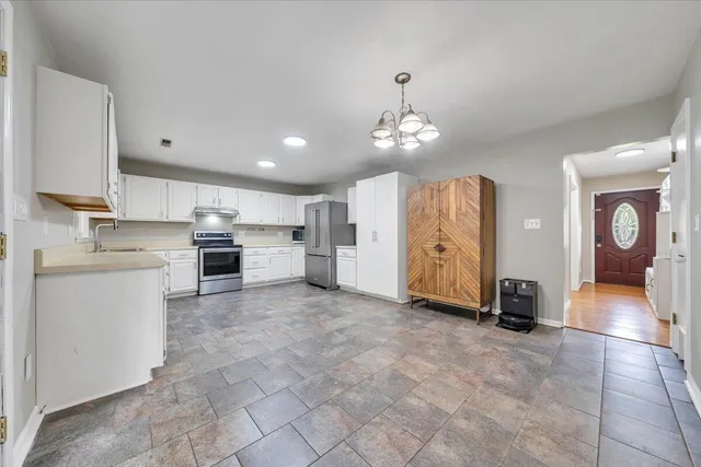 a view of a kitchen with furniture and a ceiling fan