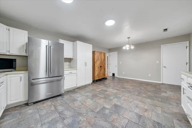 a view of a kitchen with dishwasher cabinet and window