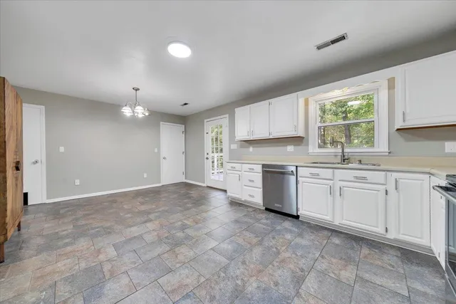 a kitchen with stainless steel appliances granite countertop a refrigerator and a stove