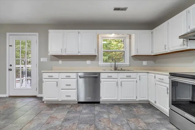 a bathroom with a granite countertop sink a mirror and toilet