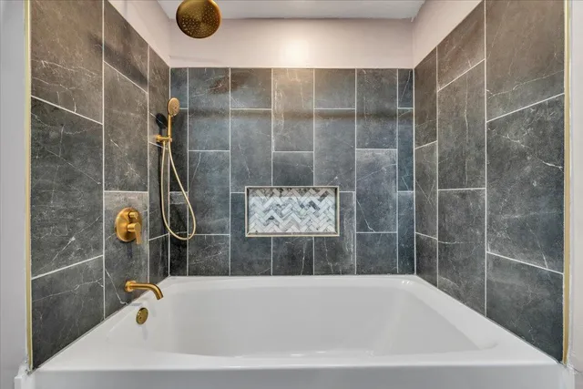 a bathroom with a tub and shower
