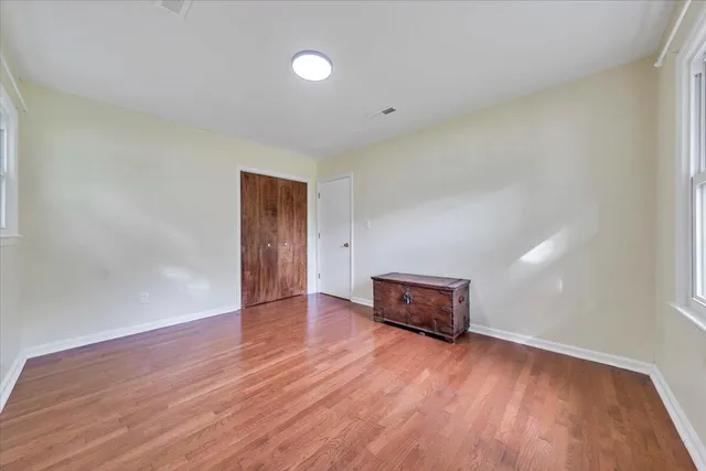 a living room with hard wood floors and a window