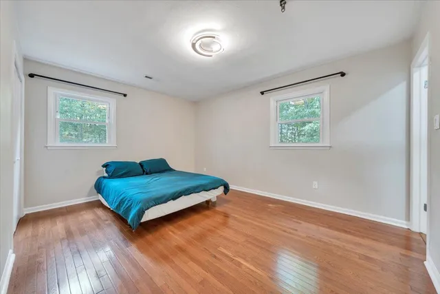 a living room with hard wood floors and a window