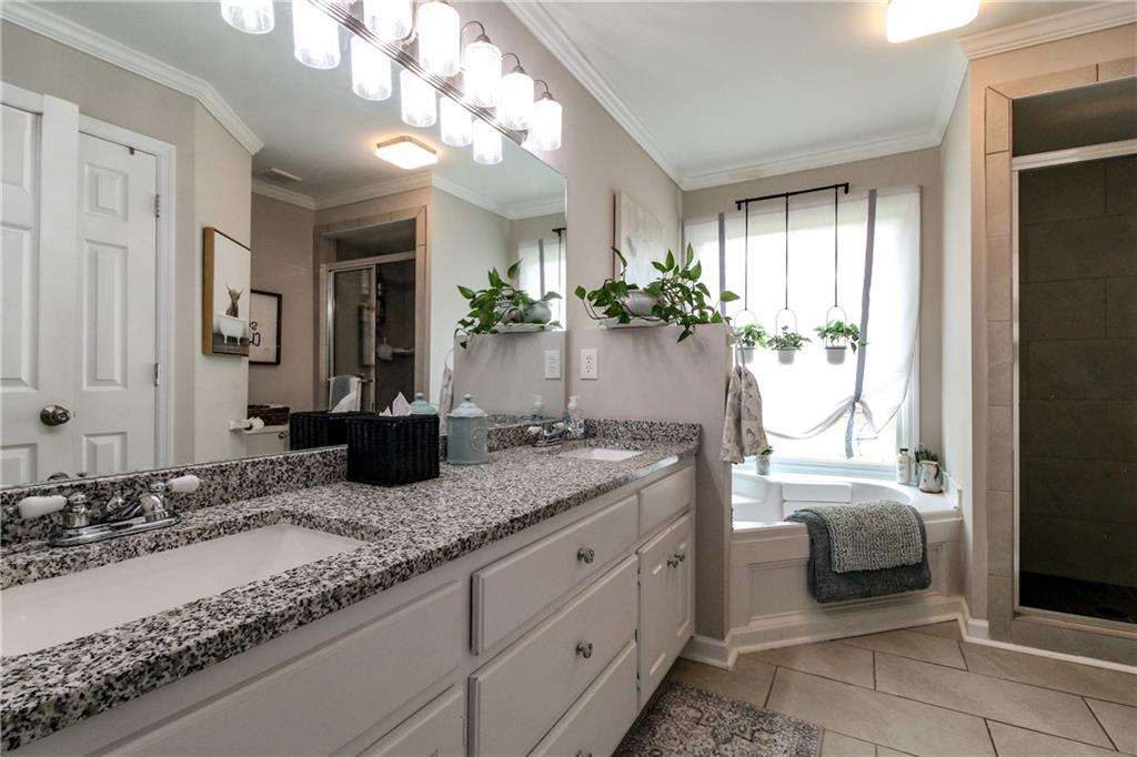 1155 Orchid Way Canton, GA 30115 - Photo 14 of 40 a bathroom with a granite countertop sink and a mirror