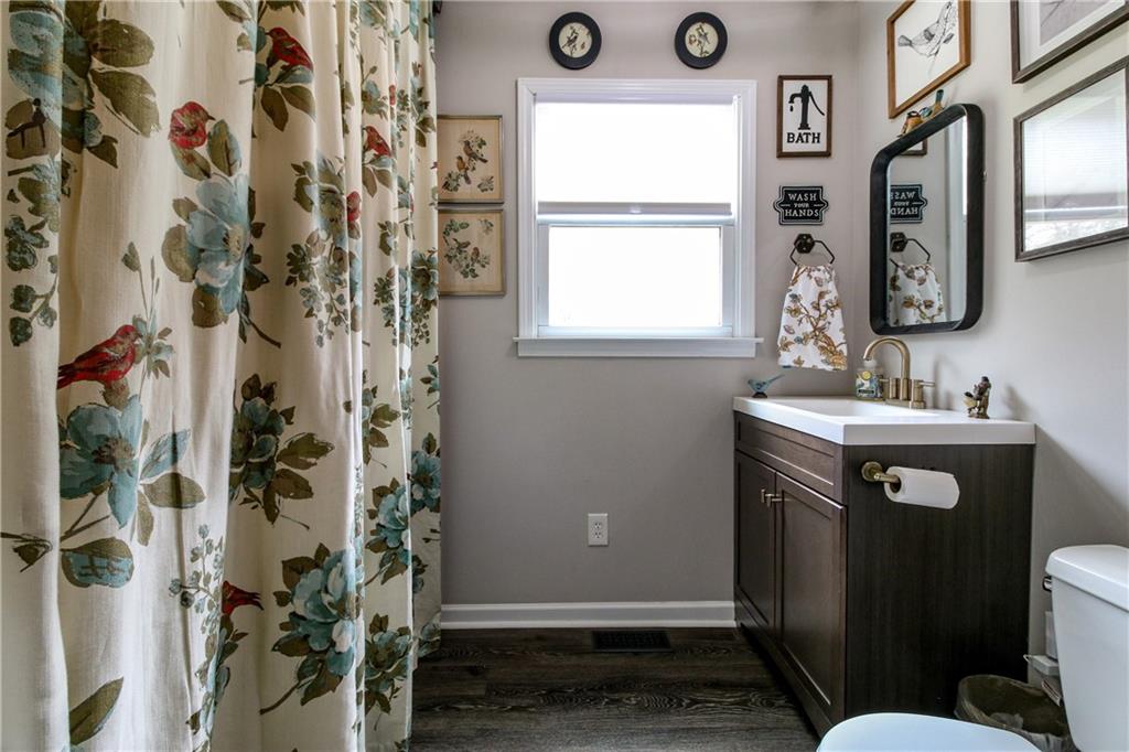 1155 Orchid Way Canton, GA 30115 - Photo 16 of 40 a bathroom with a sink and a mirror