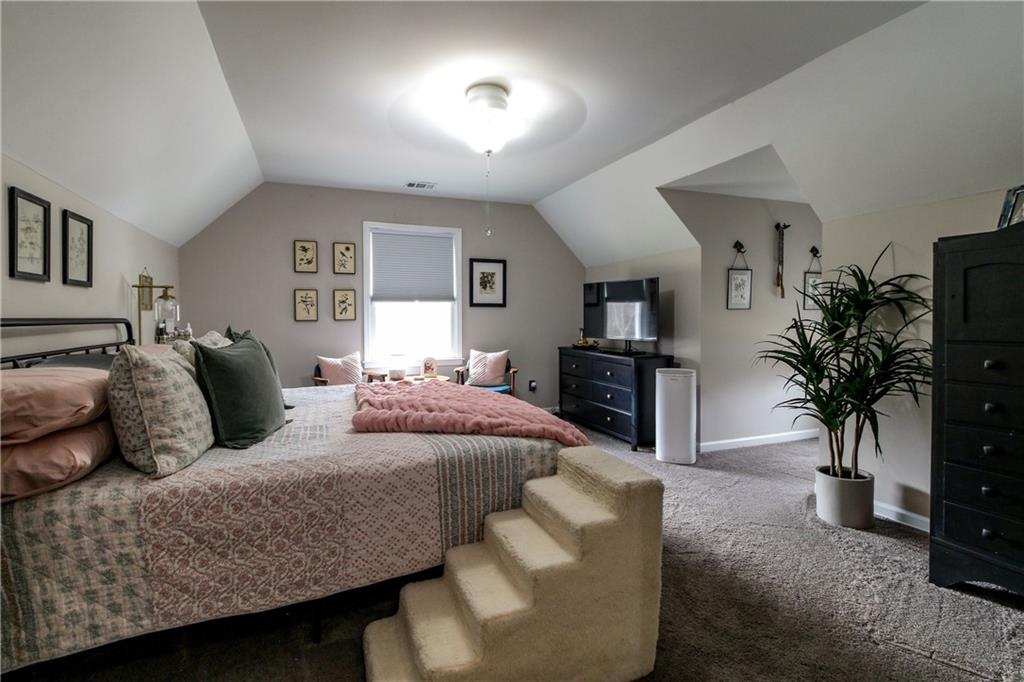 1155 Orchid Way Canton, GA 30115 - Photo 17 of 40 a living room with furniture potted plant and kitchen view