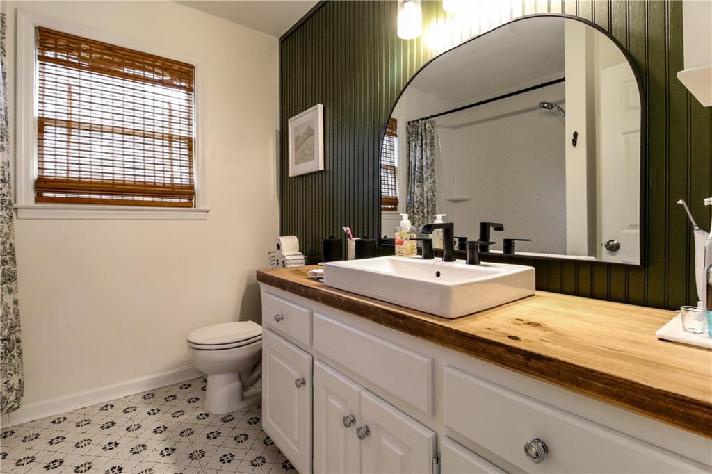 1155 Orchid Way Canton, GA 30115 - Photo 18 of 40 a bathroom with a sink and a mirror
