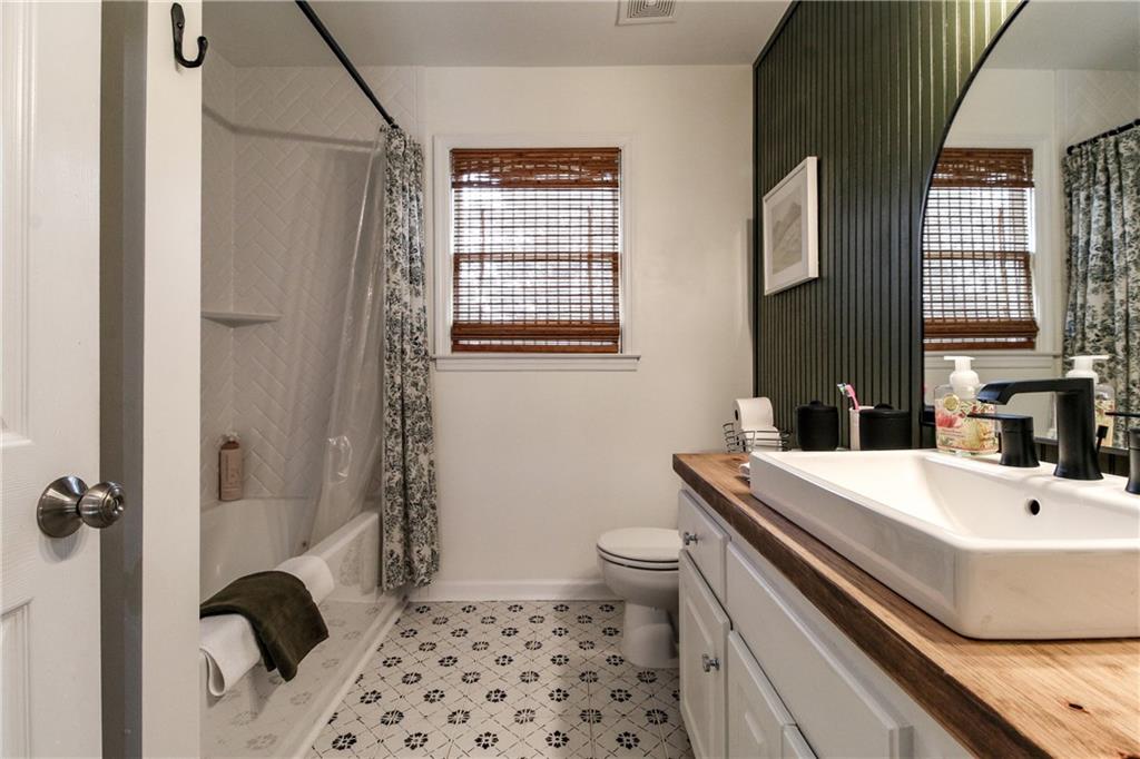 1155 Orchid Way Canton, GA 30115 - Photo 19 of 40 a bathroom with a sink a toilet and shower